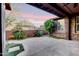 Tranquil back patio with stone accents, artificial turf, and a covered area for outdoor enjoyment at 18562 N 94Th St, Scottsdale, AZ 85255