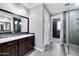 Modern bathroom features a double vanity, walk-in glass shower, and neutral tile flooring at 18562 N 94Th St, Scottsdale, AZ 85255