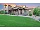 Charming home with manicured front yard, inviting porch and a well-maintained lawn at 18562 N 94Th St, Scottsdale, AZ 85255
