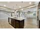 Open-concept kitchen showcasing a large center island and dark wood cabinets, seamlessly connecting to the spacious living area at 18562 N 94Th St, Scottsdale, AZ 85255
