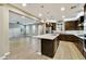 Open kitchen flowing into the living area, featuring granite countertops and stainless-steel appliances at 18562 N 94Th St, Scottsdale, AZ 85255