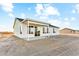 Exterior view of a home featuring large windows and a covered patio in the backyard at 18931 W Crescent Way, Buckeye, AZ 85326