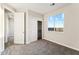 Bright bedroom with a closet, a window with a view, and carpeted flooring at 18931 W Crescent Way, Buckeye, AZ 85326