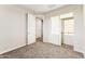 This carpeted bedroom features an open closet with white doors, offering ample storage space at 18931 W Crescent Way, Buckeye, AZ 85326