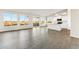 Bright and open living space with gray flooring, seamlessly connected to a modern kitchen and outdoor views at 18931 W Crescent Way, Buckeye, AZ 85326