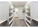 Spacious walk-in closet with plenty of shelving and a neutral carpet at 18931 W Crescent Way, Buckeye, AZ 85326