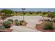 Outdoor community basketball court with landscaping, seating and multiple hoops for sports and recreation at 20251 W Madison St, Buckeye, AZ 85326