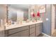 Well-lit bathroom featuring double sinks, ample counter space, and a modern aesthetic at 20251 W Madison St, Buckeye, AZ 85326
