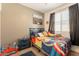 bedroom with a playful theme, featuring colorful bedding, toys, and ample natural light at 20251 W Madison St, Buckeye, AZ 85326