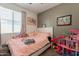 Bedroom with a soft color palette, plush bedding, and a cozy atmosphere at 20251 W Madison St, Buckeye, AZ 85326