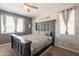 Comfortable bedroom featuring a large bed with a decorative headboard, brick accent wall and abundant natural light at 20251 W Madison St, Buckeye, AZ 85326