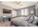 Bedroom with TV, ceiling fan, and gray walls offer a relaxing and comfortable living space at 20251 W Madison St, Buckeye, AZ 85326