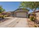 Charming single-story home featuring a two-car garage and low-maintenance desert landscaping at 20251 W Madison St, Buckeye, AZ 85326