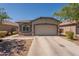 Charming single-story home featuring a two-car garage and low-maintenance desert landscaping at 20251 W Madison St, Buckeye, AZ 85326
