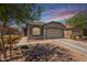 Single-story home with a two-car garage, desert landscaping, and inviting curb appeal at 20251 W Madison St, Buckeye, AZ 85326