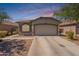 Inviting single-story home featuring a two-car garage and low-maintenance desert landscaping at 20251 W Madison St, Buckeye, AZ 85326