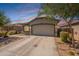 Charming single-story home boasts a well-maintained front yard and attached two-car garage at 20251 W Madison St, Buckeye, AZ 85326