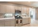 Well-lit kitchen boasting stainless steel appliances, white cabinets, and a stylish backsplash, great for cooking at 20251 W Madison St, Buckeye, AZ 85326