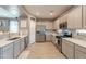 Bright kitchen showcasing stainless steel appliances, white cabinets, and a stylish backsplash, ideal for cooking at 20251 W Madison St, Buckeye, AZ 85326