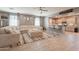 Open-concept living room with a large sectional sofa and seamless flow into the kitchen at 20251 W Madison St, Buckeye, AZ 85326