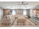 Inviting living room featuring a ceiling fan, comfortable seating, and seamless flow into the kitchen at 20251 W Madison St, Buckeye, AZ 85326