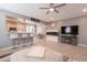 Bright and airy living room featuring a TV, aquarium, and breakfast bar with seamless flow to the kitchen at 20251 W Madison St, Buckeye, AZ 85326