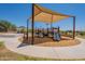 Community playground with shaded play structure, slide, and climbing wall for outdoor Gathering fun at 20251 W Madison St, Buckeye, AZ 85326