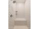 Shower featuring white subway tile, a built-in bench, and convenient shelving at 20251 W Madison St, Buckeye, AZ 85326