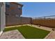 Low-maintenance backyard with artificial turf and desert landscaping at 21047 N 58Th Way, Phoenix, AZ 85054