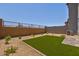 Backyard featuring low-maintenance desert landscaping, turf, and privacy walls at 21047 N 58Th Way, Phoenix, AZ 85054