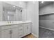 Bathroom view with a double sink vanity, granite countertop, and a door to the closet at 21047 N 58Th Way, Phoenix, AZ 85054