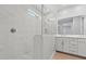 Modern bathroom with walk-in glass shower, neutral tile and double sink vanity at 21047 N 58Th Way, Phoenix, AZ 85054