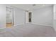 Large bedroom with carpet, ensuite bathroom, and view of black metal staircase at 21047 N 58Th Way, Phoenix, AZ 85054