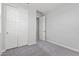 Neutral bedroom featuring a closet with white doors, carpet and neutral colored walls at 21047 N 58Th Way, Phoenix, AZ 85054