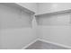 Interior view of the walk-in closet showcasing ample storage space with shelving at 21047 N 58Th Way, Phoenix, AZ 85054