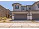 Two-story home featuring a spacious two car garage, stone accents, and a well-maintained paver driveway at 21047 N 58Th Way, Phoenix, AZ 85054