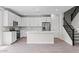 Modern kitchen with stainless steel appliances, a center island, white cabinets, and tile backsplash at 21047 N 58Th Way, Phoenix, AZ 85054