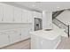 Bright, all-white kitchen with stainless steel appliances and a quartz countertop island at 21047 N 58Th Way, Phoenix, AZ 85054