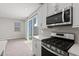 Modern kitchen featuring stainless steel appliances, gas range, and sliding glass door to backyard at 21047 N 58Th Way, Phoenix, AZ 85054