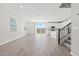 Open-concept living area with tile flooring, modern kitchen, backyard access, and staircase at 21047 N 58Th Way, Phoenix, AZ 85054