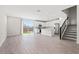 Bright living room with modern kitchen, stainless appliances, tile flooring, and sliding door to backyard at 21047 N 58Th Way, Phoenix, AZ 85054