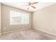 Bright bedroom with neutral paint, carpet, ceiling fan and a large window at 2134 E Broadway Rd # 2030, Tempe, AZ 85282