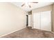 This carpeted bedroom offers neutral paint, closet and easy access to adjacent bathroom at 2134 E Broadway Rd # 2030, Tempe, AZ 85282