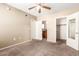 Neutral bedroom features two doors, carpet, and a ceiling fan with a light at 2134 E Broadway Rd # 2030, Tempe, AZ 85282