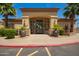 Clubhouse entrance features double glass doors and desert landscaping, including well-manicured palms and planters at 2134 E Broadway Rd # 2030, Tempe, AZ 85282