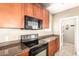 Galley kitchen features stainless steel appliances, black oven and granite countertops at 2134 E Broadway Rd # 2030, Tempe, AZ 85282