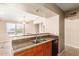 Modern kitchen boasts granite countertops, stainless steel sink, and bar seating at 2134 E Broadway Rd # 2030, Tempe, AZ 85282