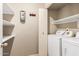 This laundry room is equipped with a washer and dryer and convenient shelving space at 2134 E Broadway Rd # 2030, Tempe, AZ 85282