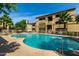 Community pool surrounded by well-maintained landscaping and multiple-story apartment buildings at 2134 E Broadway Rd # 2030, Tempe, AZ 85282