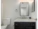 Bathroom with modern vanity featuring black cabinets, white countertop and black framed mirror at 21655 N 36Th Ave # 131, Glendale, AZ 85308